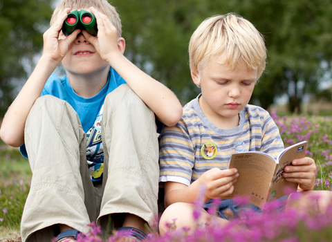 Two children with binoculars in heather