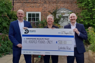 3 men holding a large cheque made out to SWT for £500